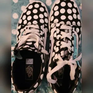 Black and White Polka Dot Vans with an Aqua Zipper on both shoes
