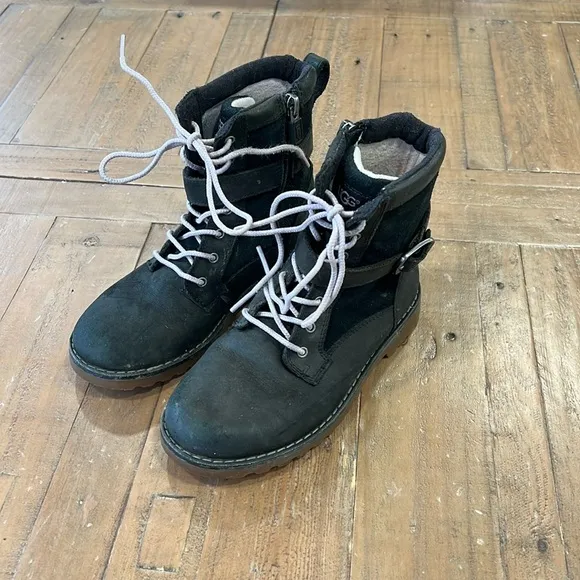 Ugg Koren black leather buckle strap lug sole boots