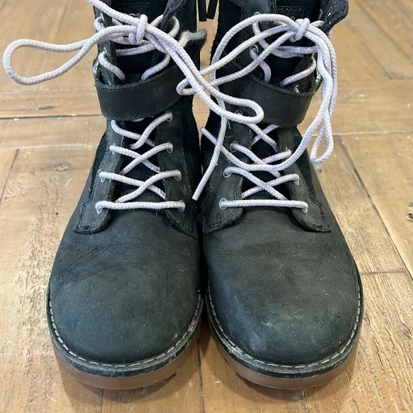 Ugg Koren black leather buckle strap lug sole boots