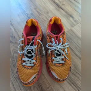 Women's Orange and red 15 Brooks GTS in a size 7.5. Running sneakers.